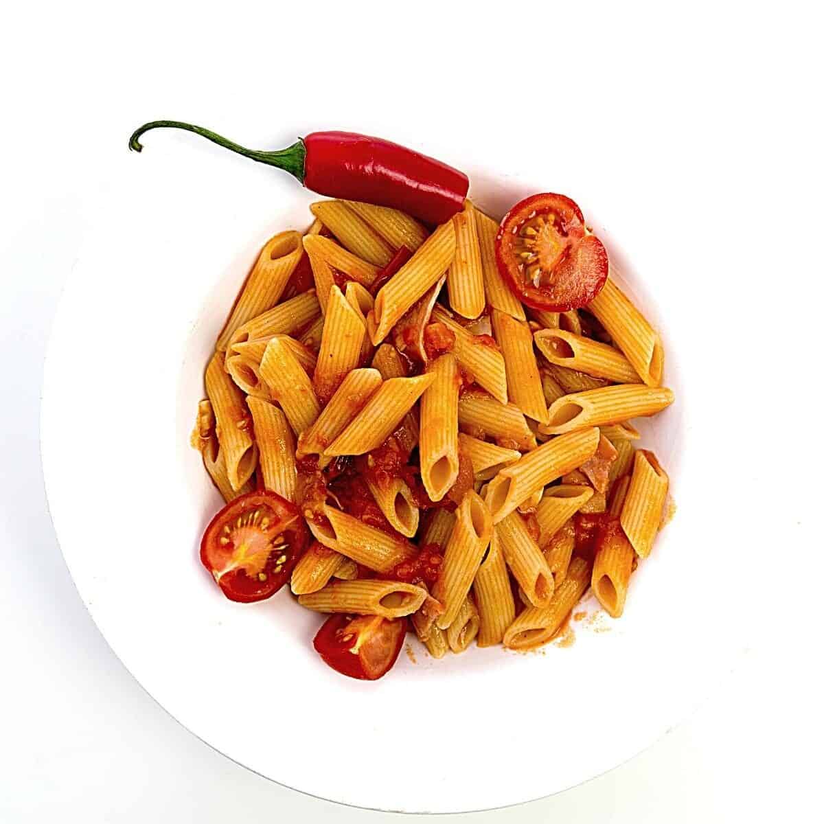 White plate with Slimming World pasta arrabiata and red chilli