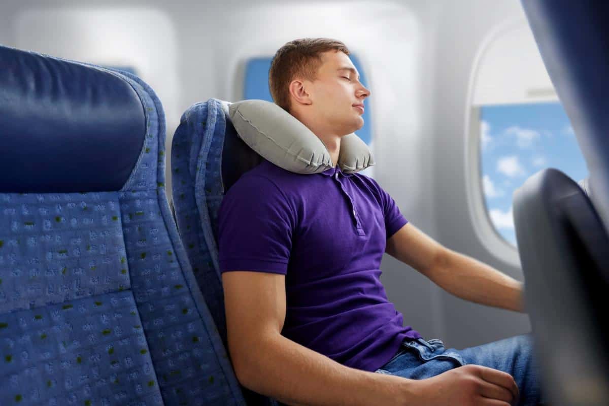 man asleep on an aeroplane.