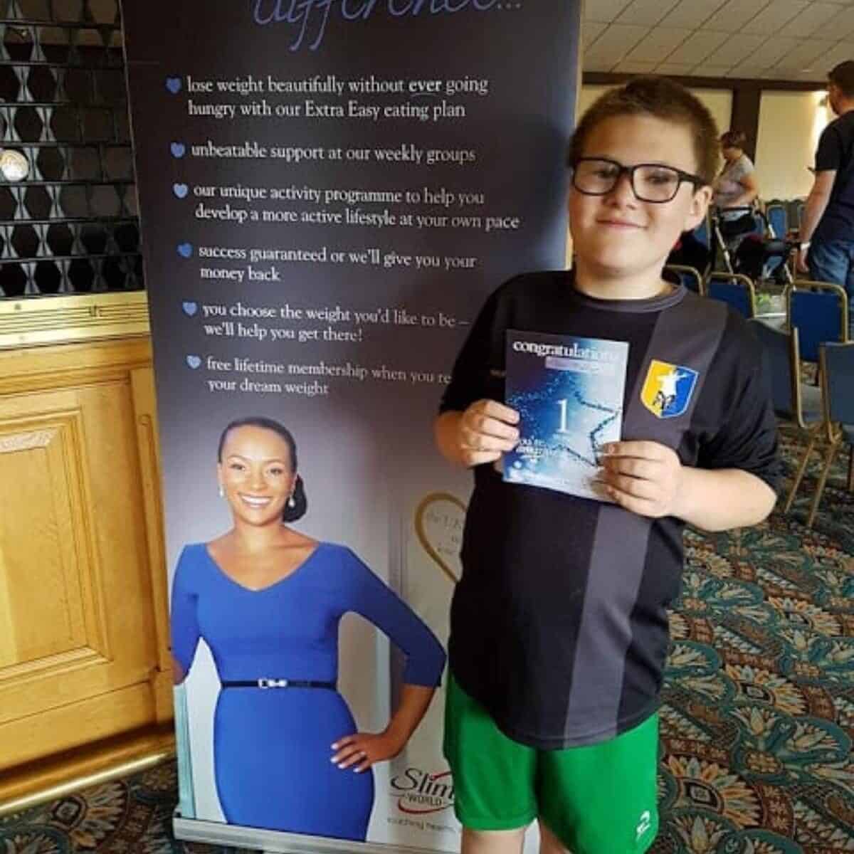 boy holding certificate