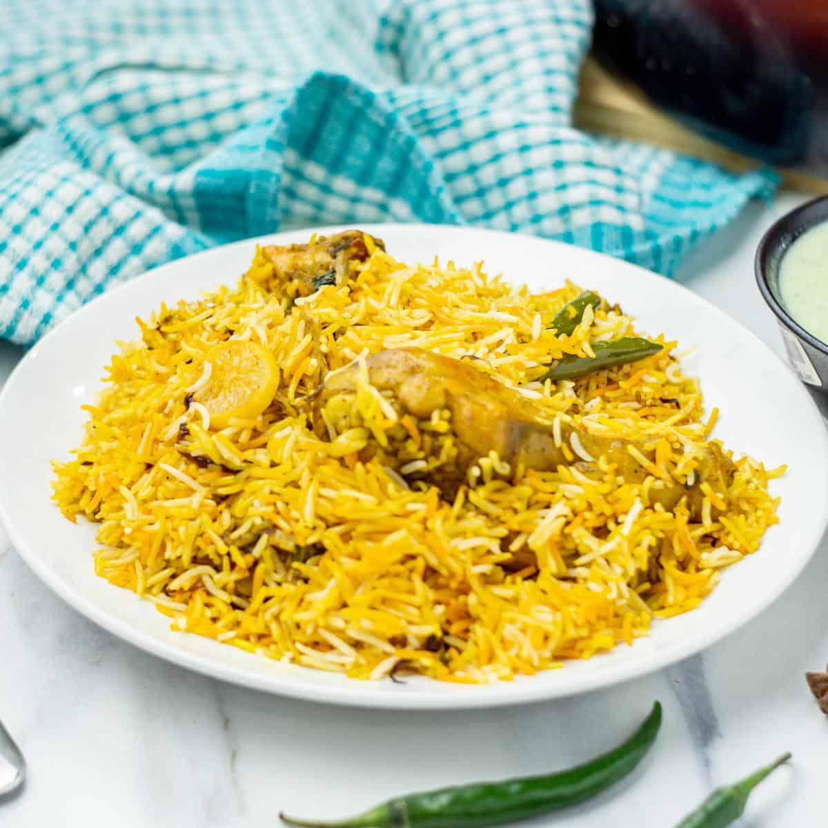 chicken biryani in a white bowl