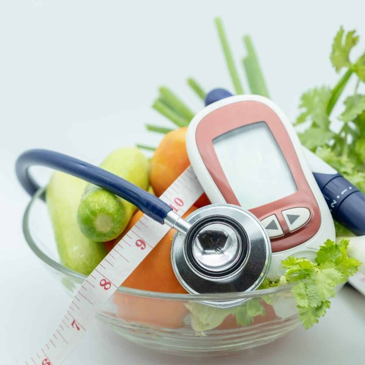 diabetes monitor, vegetables and a stethoscope.