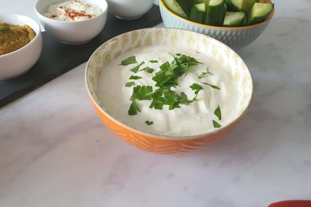 Garlic dip in an orange bowl