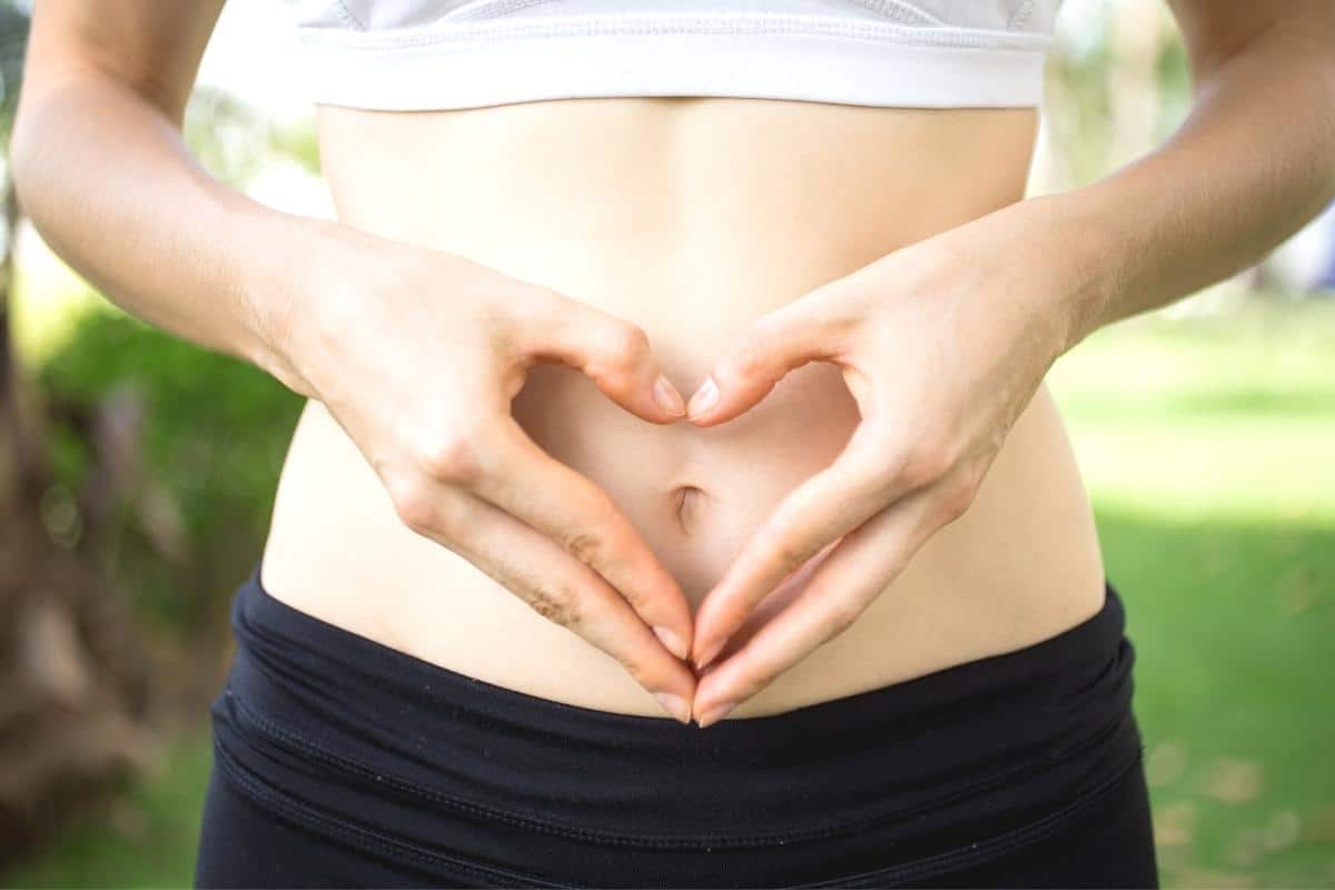 lady with heart on her tummy made with her hands