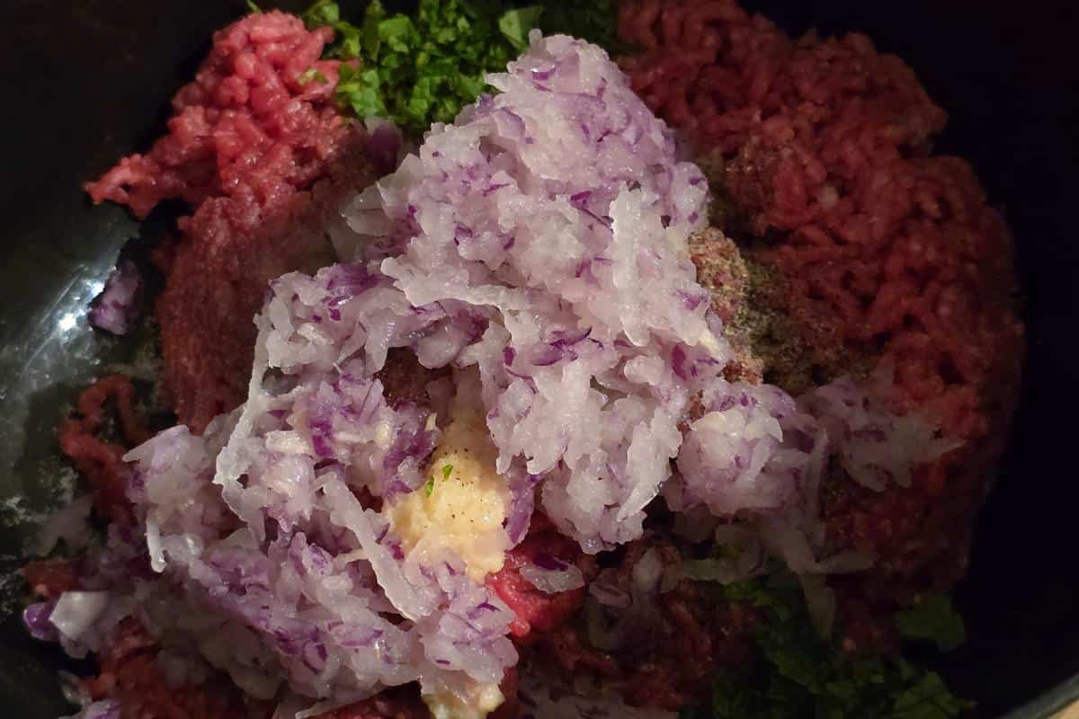 This easy recipe features a ground meat mixture with chopped red onions, garlic, and herbs. Perfect for crafting a delicious minted lamb burger or any healthy dish you're in the mood for.