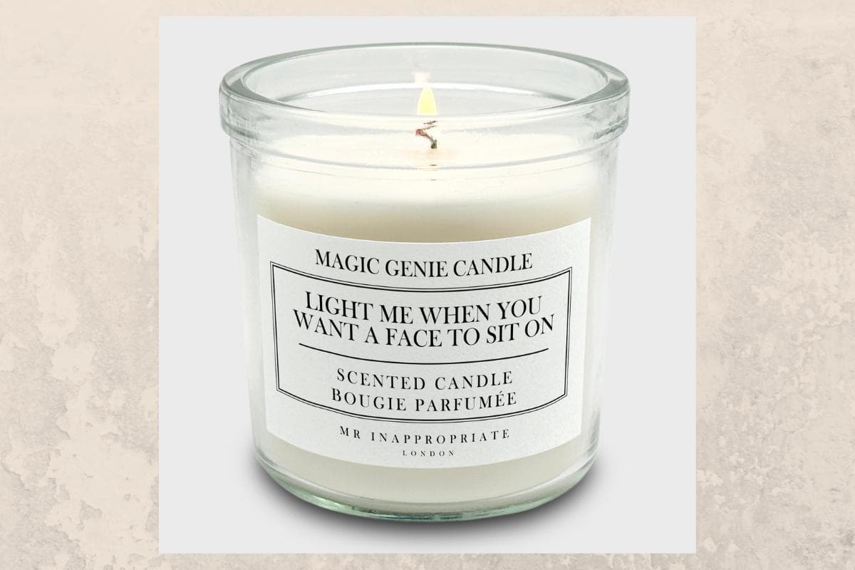 Glass jar candle labeled "Magic Genie Candle," with text: "Light me when you want a face to sit on. Scented candle." Makes a lovely gift for those who appreciate humor and delightful scents.