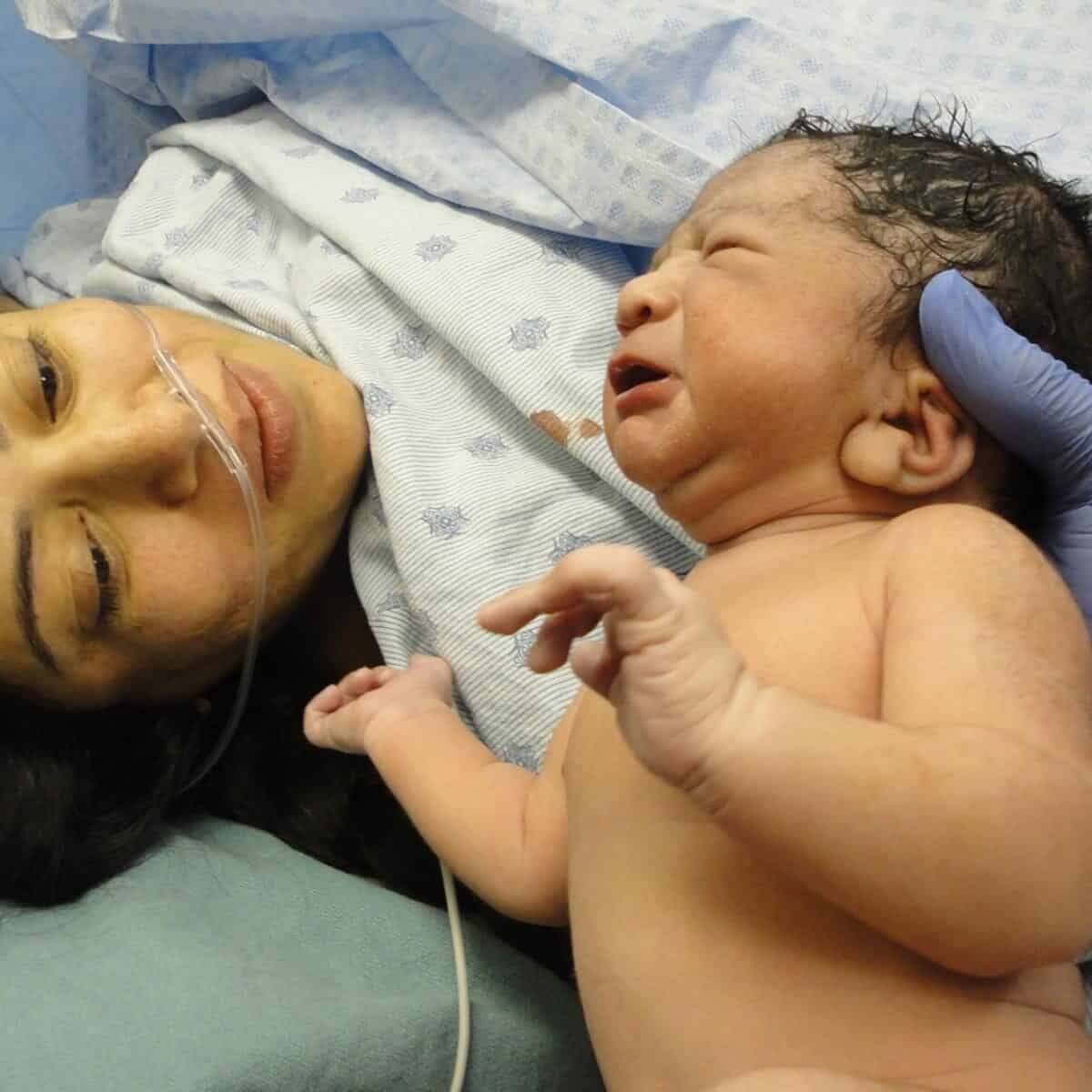 Newborn baby with mother just after a c section birth