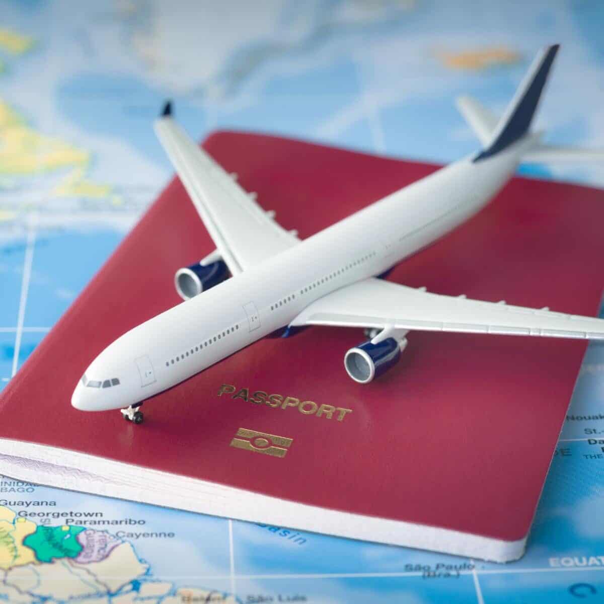 travel picture of toy plane and passport on a map