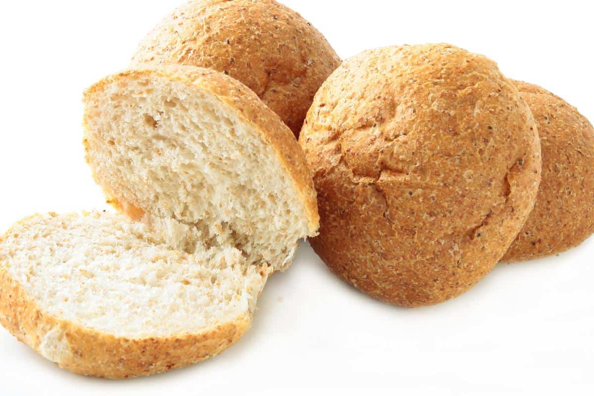 wholemeal bread rolls and one has been cut open.